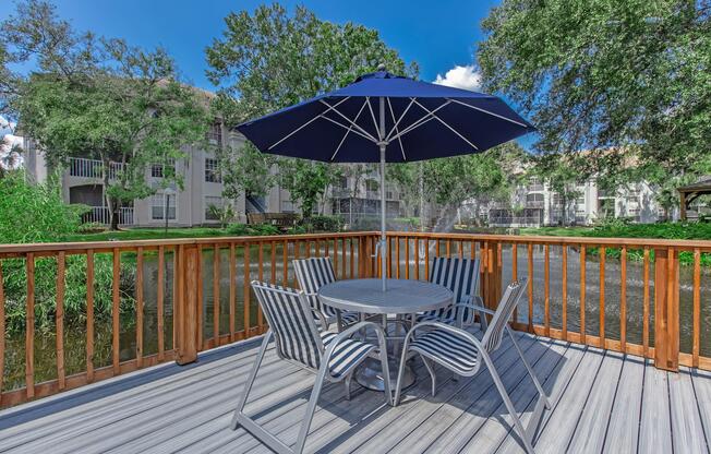 a couple of lawn chairs sitting on top of a wooden fence