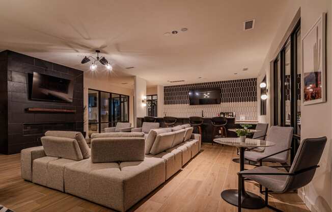 a living room with couches and chairs and a television