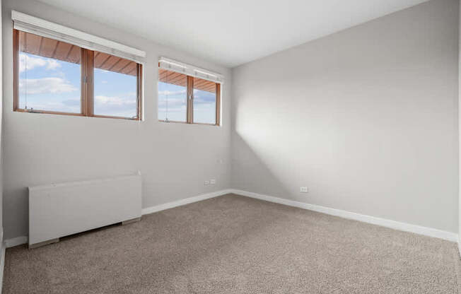 A room with a window and a radiator on the wall.