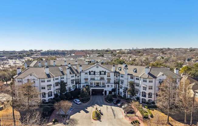 A large white building with a driveway in front.