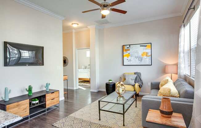Horizon at Premier Apartments Living Room Model with Ceiling Fan and Large Window.