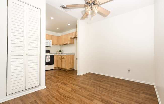 Dining area with ceiling fan and kitchen at Woodbend, Alta Loma, CA, 91701