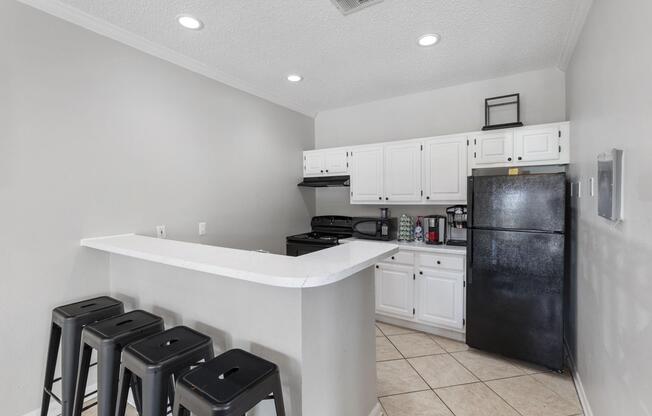 a kitchen with a sink and a refrigerator