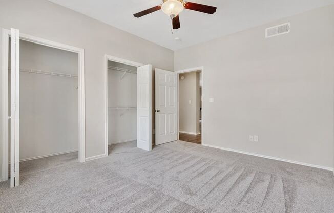 Luxury One Bedroom Apartments in Plano, TX - Carrington Park Apartments Bedroom With Ceiling Fan, Plush Carpeting and Large Closets