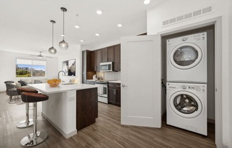 a kitchen with a washing machine and a washer and dryer