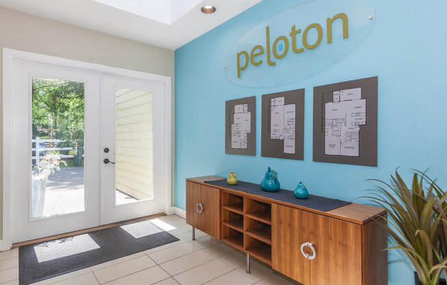 a room with a blue wall and a door that says peleton