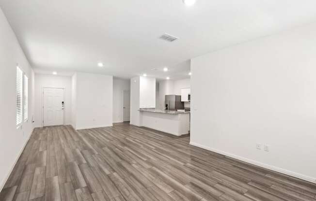 the living room and kitchen with hardwood floor