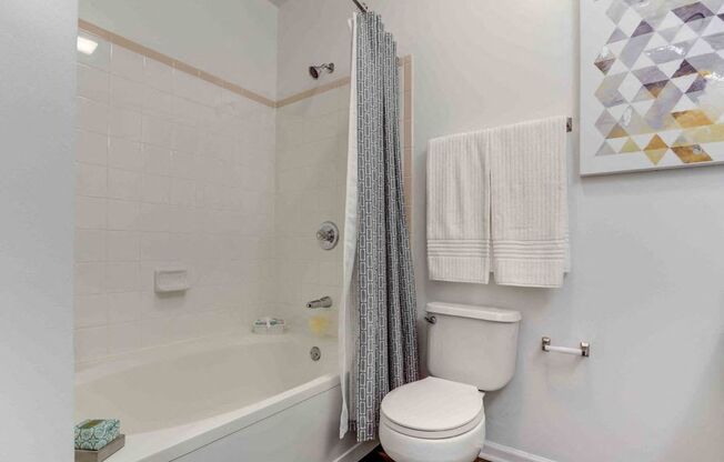a bathroom with a toilet and a tub