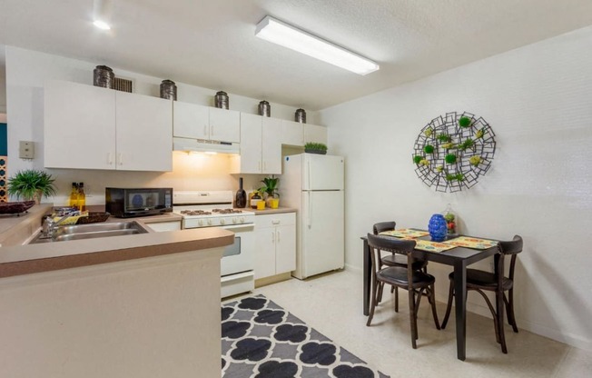 Fully Equipped Kitchen with table, chairs, and refrigerator