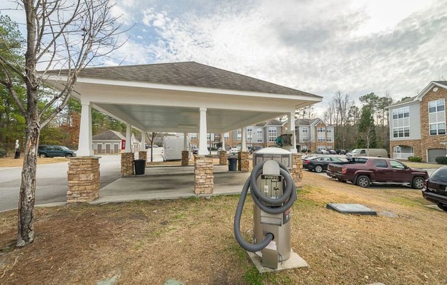 a parking meter sitting in front of a parking lot