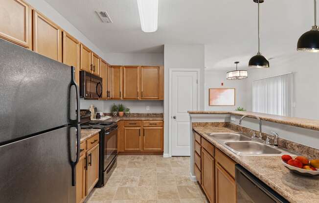 a kitchen with wood cabinets and black appliances