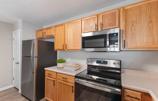 Hard wood cabinets with Stainless Steel Appliances and Flat Top Stove