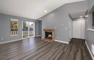 A living room with a fireplace and sliding glass doors.