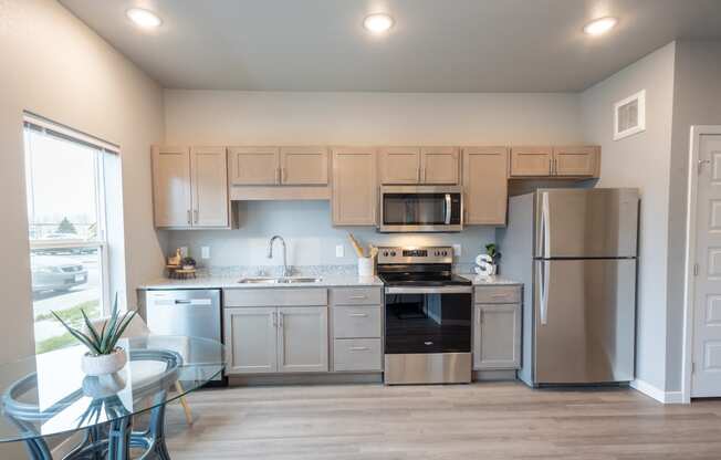 a kitchen with stainless steel appliances and white cabinets