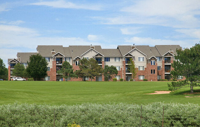 Westlake Greens brick apartment buildings with green grass and trees in front