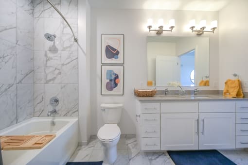 a white bathroom with a shower toilet and sink