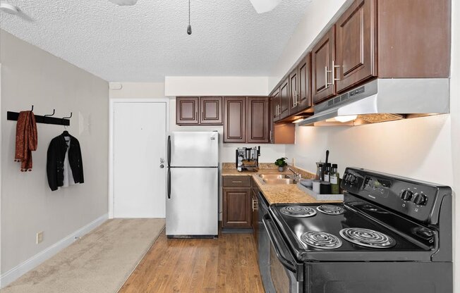 a kitchen with stainless steel appliances and wooden cabinets