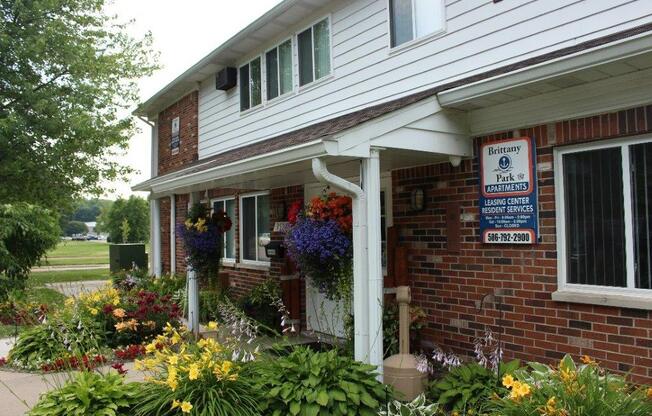 a flower garden in front of a house