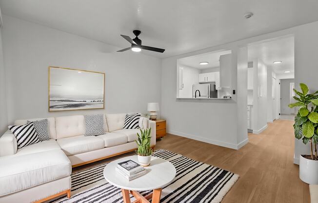 A living room with a white couch and a coffee table.