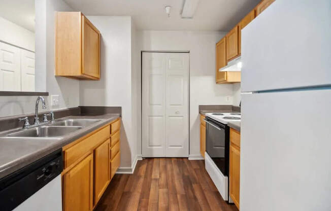 A kitchen with wooden cabinets and a white refrigerator.