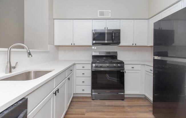 a stove top oven sitting inside of a kitchen