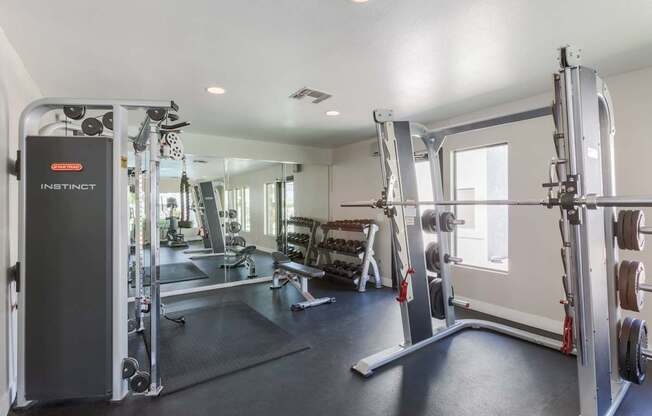 A gym with a row of exercise machines.