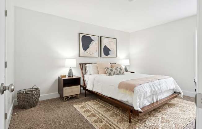 a bedroom with a bed and two night stands with lamps at Linkhorn Bay Apartments, Virginia, 23451