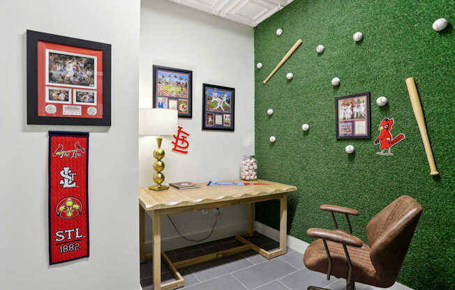 A room with a green wall and a wooden desk with a chair.