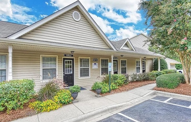 A building with a parking lot in front of it.