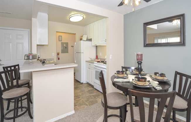 a dining room and kitchen with a dining table and chairs