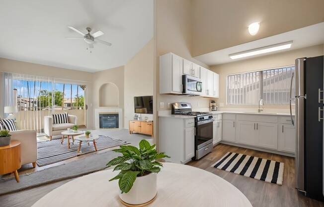 an open living room with a kitchen and a living room