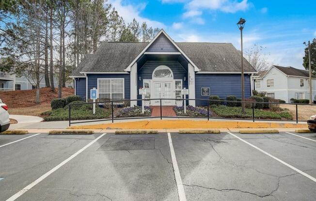 an empty parking lot in front of a blue house at The Sapphire, Decatur, GA
