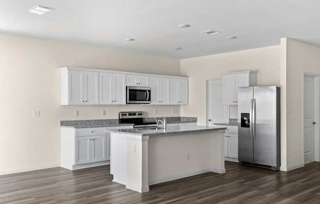 a kitchen with an island and stainless steel appliances