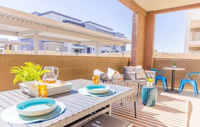 a furnished patio with a dining table and chairs