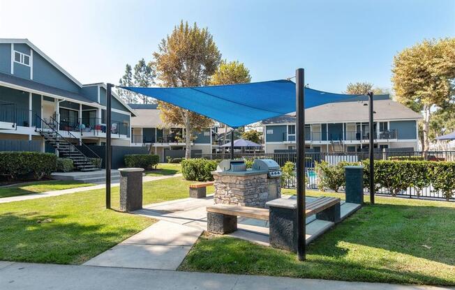 Pet Friendly Apartments in Riverside, CA - Veranda Riverside - Outdoor BBQ Grilling Area, Seating, and Lush Landscaping