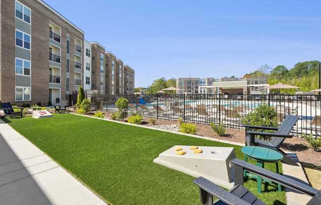A sunny day at a residential complex with a pool and a picnic table.