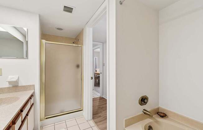 A bathroom with a walk-in shower and a toilet at Hampton Apartments, Clearwater