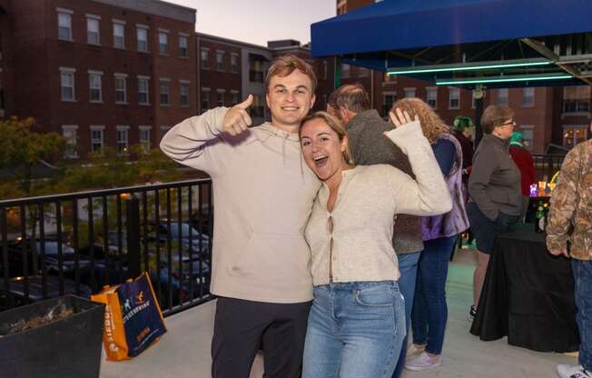 a man and woman posing for a picture at a party