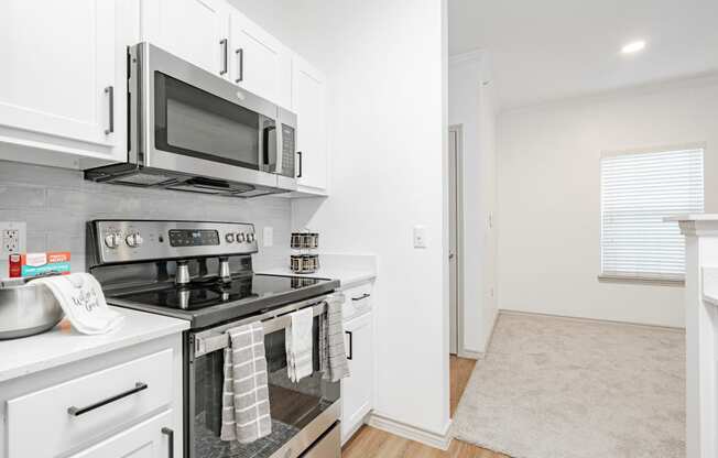 a kitchen with stainless steel appliances and a microwave