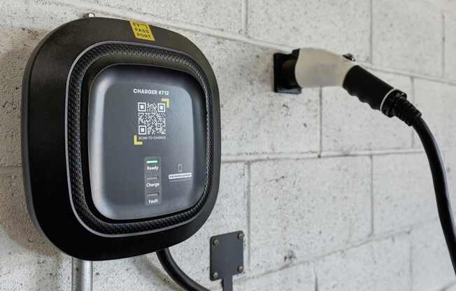A Charge 972 electric vehicle charging station is plugged into a wall socket.
