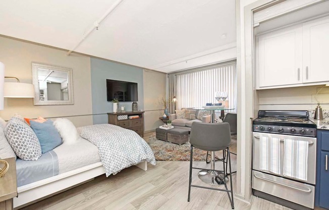 kitchen with stainless steel stove, and large living and bedroom area