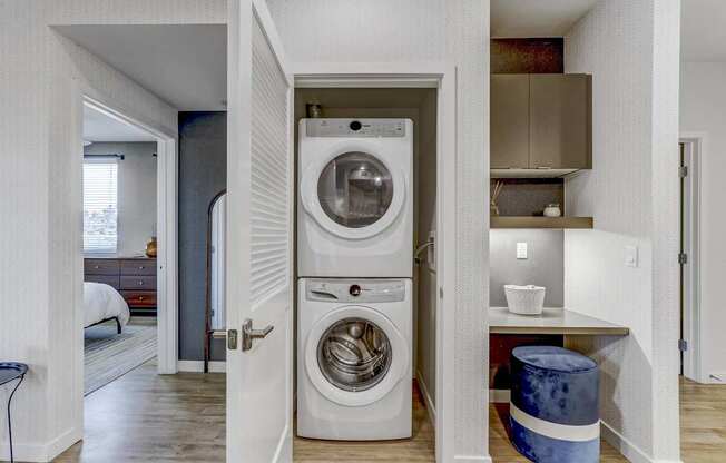 A washer and dryer are built into a wall in a small room.