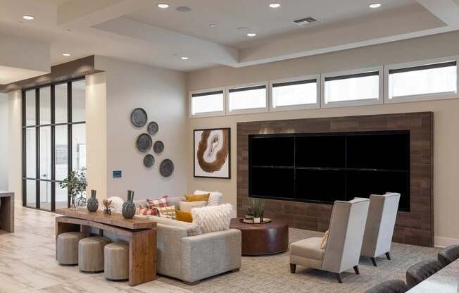 A modern living room with a fireplace and a large painting on the wall.