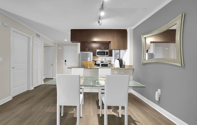 A kitchen with a table and chairs in the middle of the room.