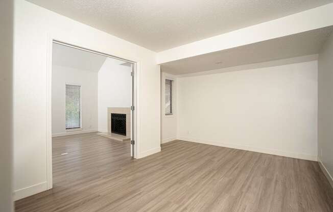 a bedroom with a fireplace and hardwood floors