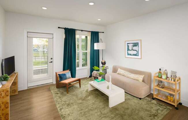 A living room with a couch, a chair, a coffee table, and a TV.