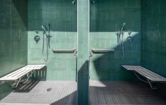 A public bathroom with two sinks and two benches.