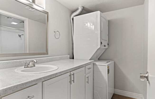 a bathroom with a sink and a washer and dryer