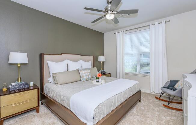 a bedroom with a bed and desk in a hotel room