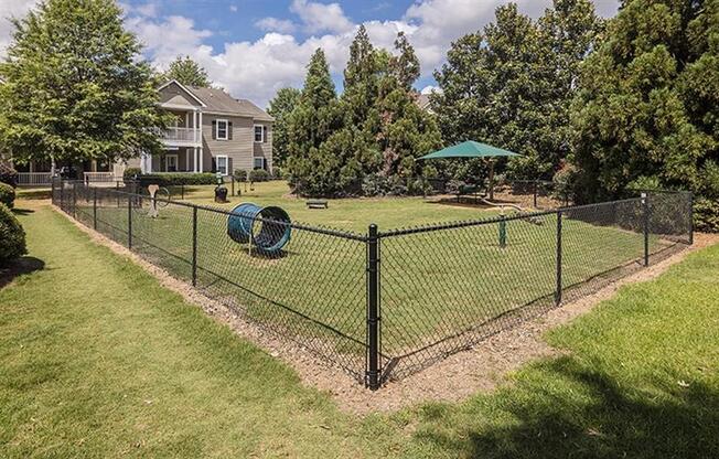 a yard with a chain link fence and a playground at Bedford Parke Apartments, Warner Robins, 31088